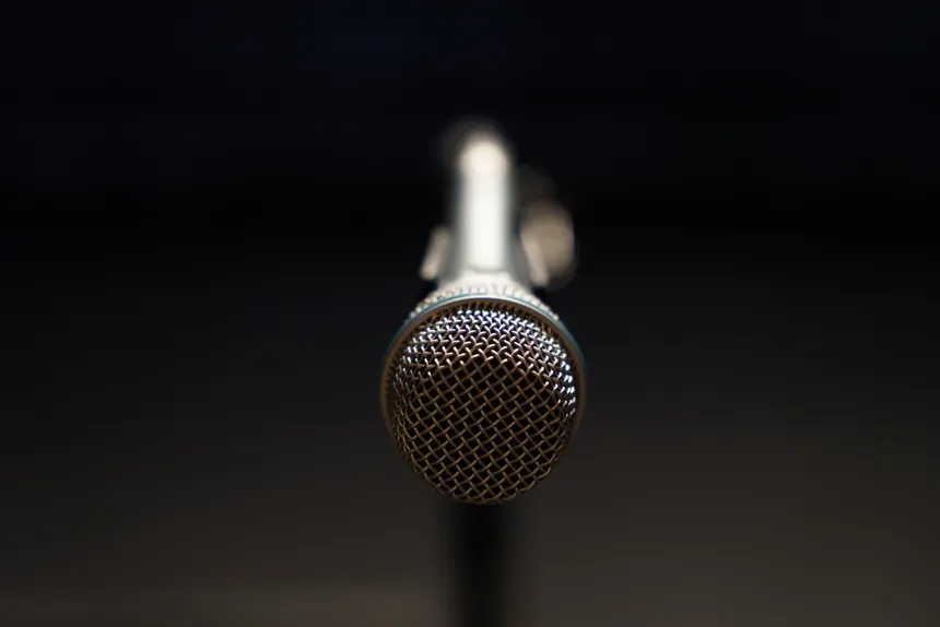 Detailed close-up of a microphone in focus, ideal for music and broadcasting themes.